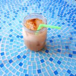 Iced Chai Latte on a Blue Tile Table
