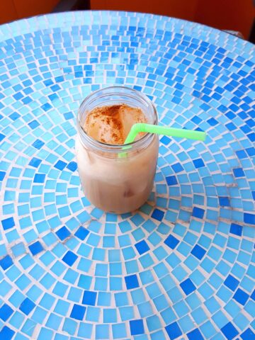 Iced Chai Latte on a Blue Tile Table