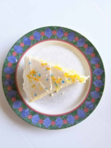 Top down shot of lemon cake with zesty lemon frosting and sprinkles