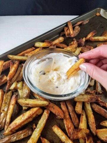 Easy Oven fries on a tray with garlic aioli