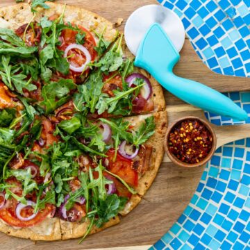15 Minute BLT Flatbread Pizza on cutting board and blue tile table