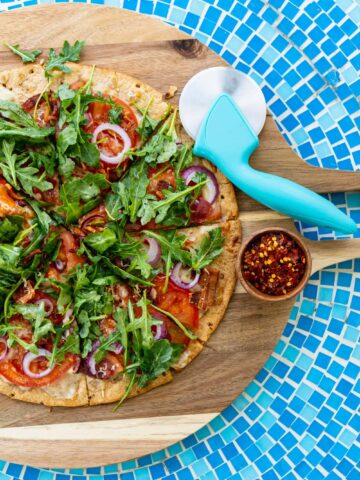 15 Minute BLT Flatbread Pizza on cutting board and blue tile table