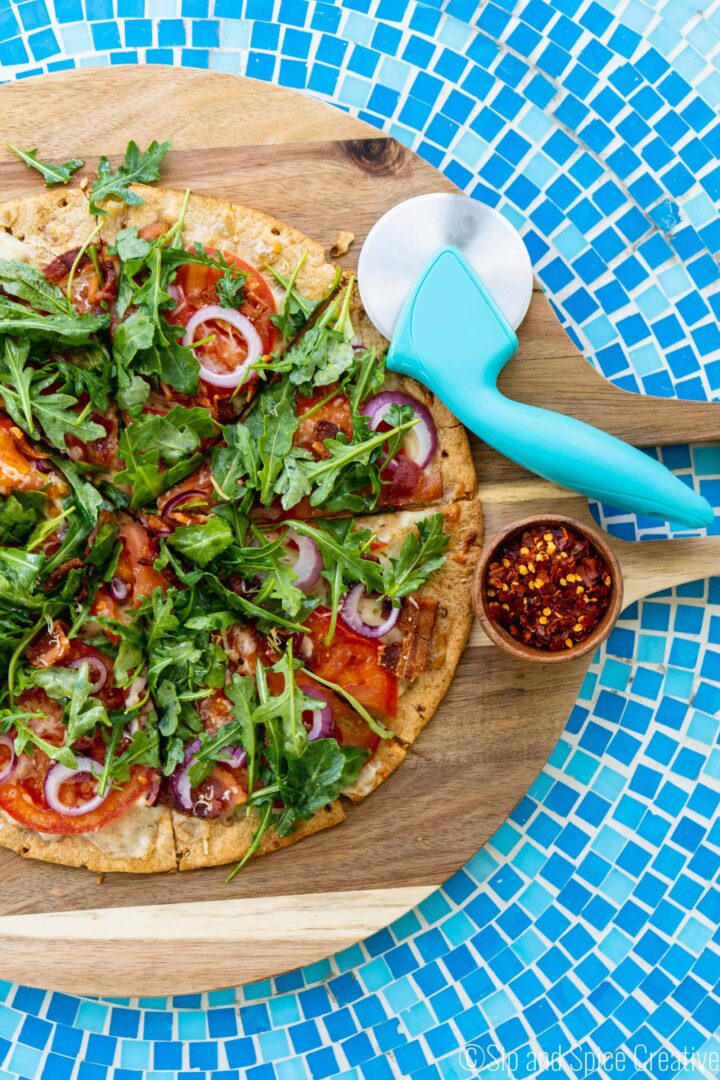 15 Minute BLT Flatbread Pizza on cutting board and blue tile table